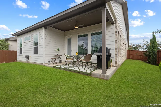 a view of an chairs and table in patio