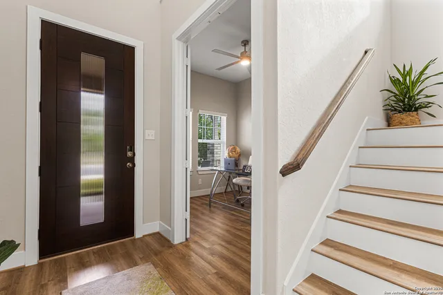 a view of entryway and hall with wooden floor