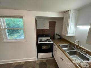 1141 6th Street Lancaster, SC 29720 - Photo 4 of 18 a kitchen with a stove a sink and a window