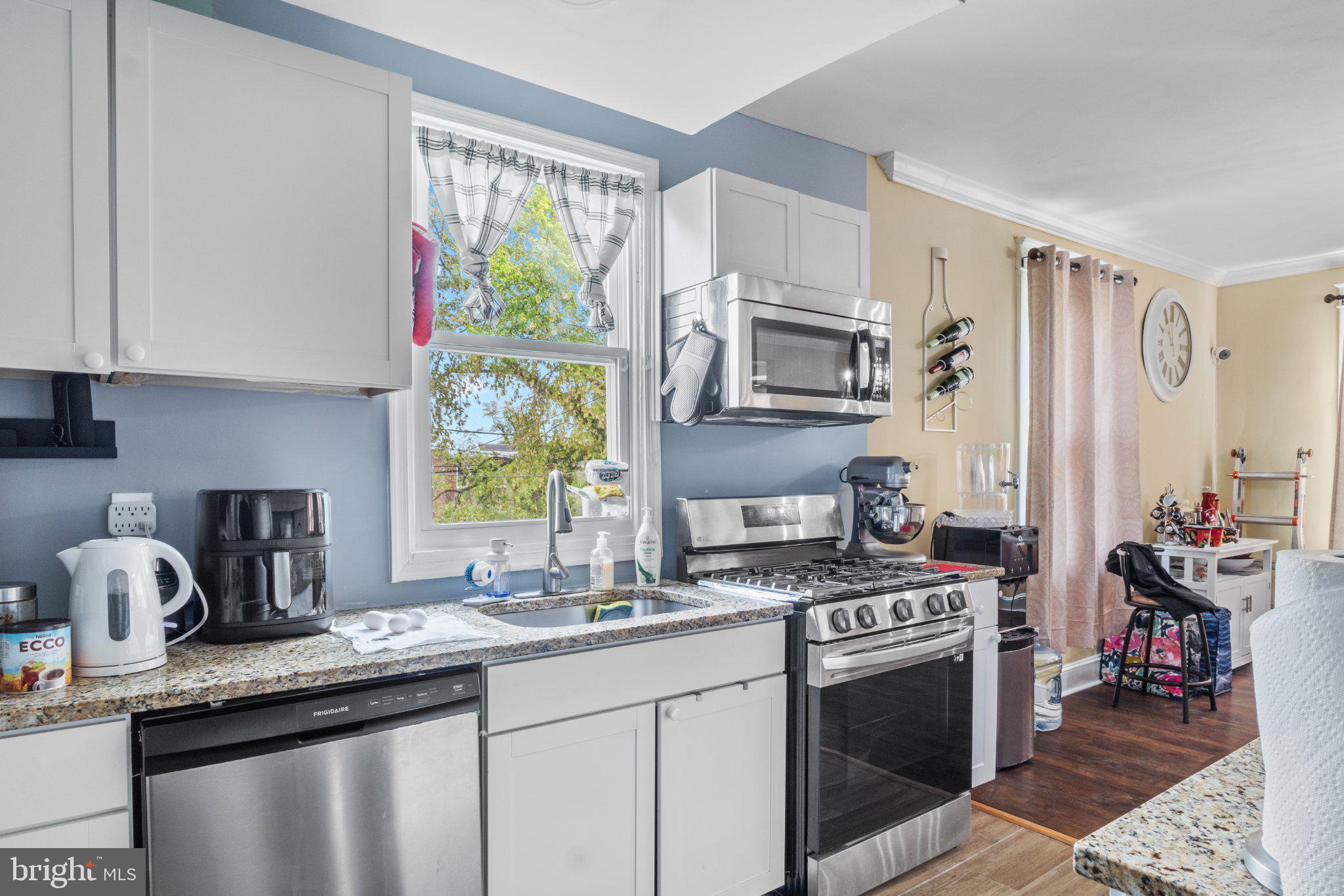 130 West Edgevale Road Baltimore, MD 21225 - Photo 14 of 37 a kitchen with stainless steel appliances a stove a sink and a microwave