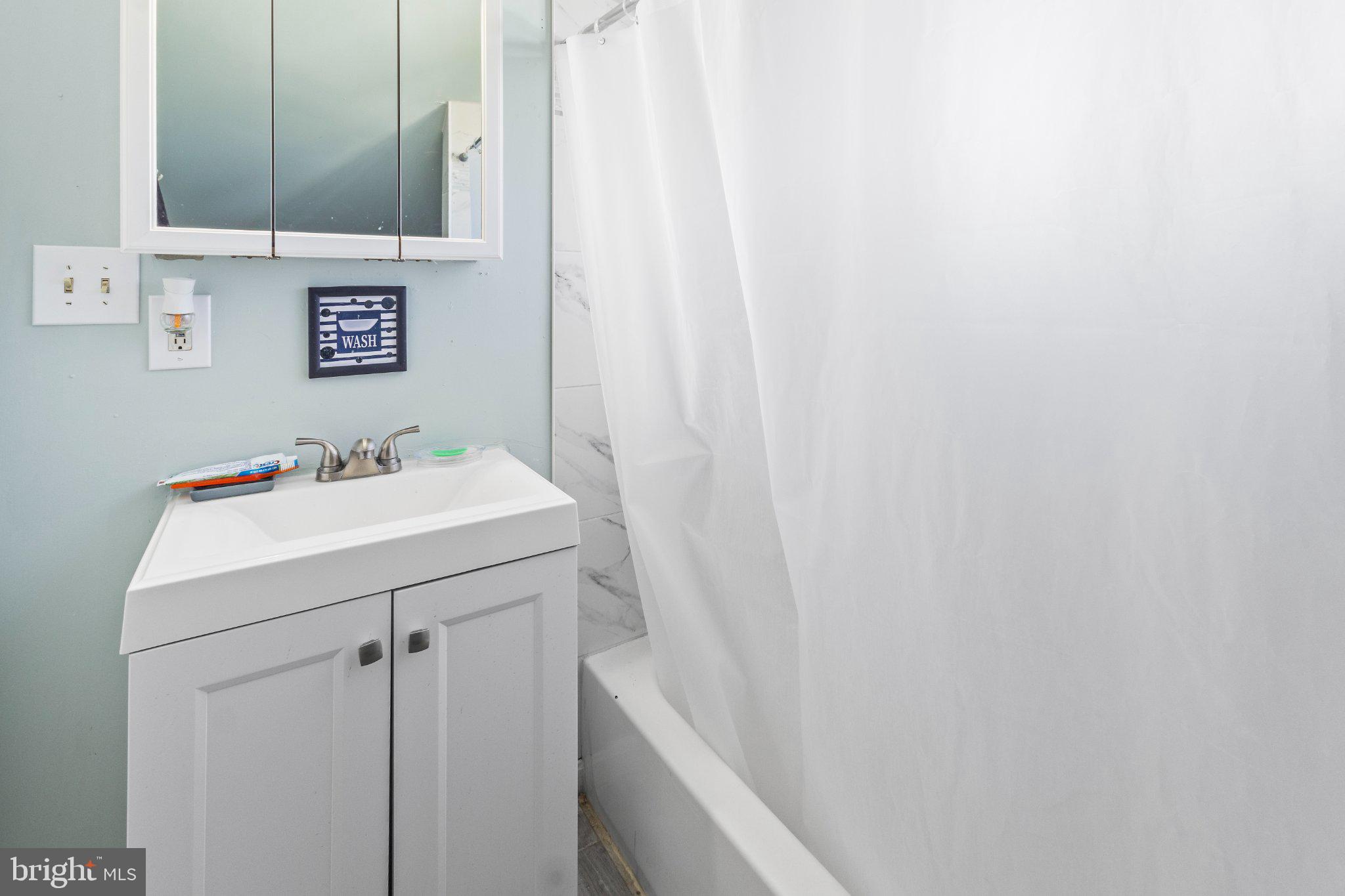 130 West Edgevale Road Baltimore, MD 21225 - Photo 18 of 37 a bathroom with a sink and a mirror