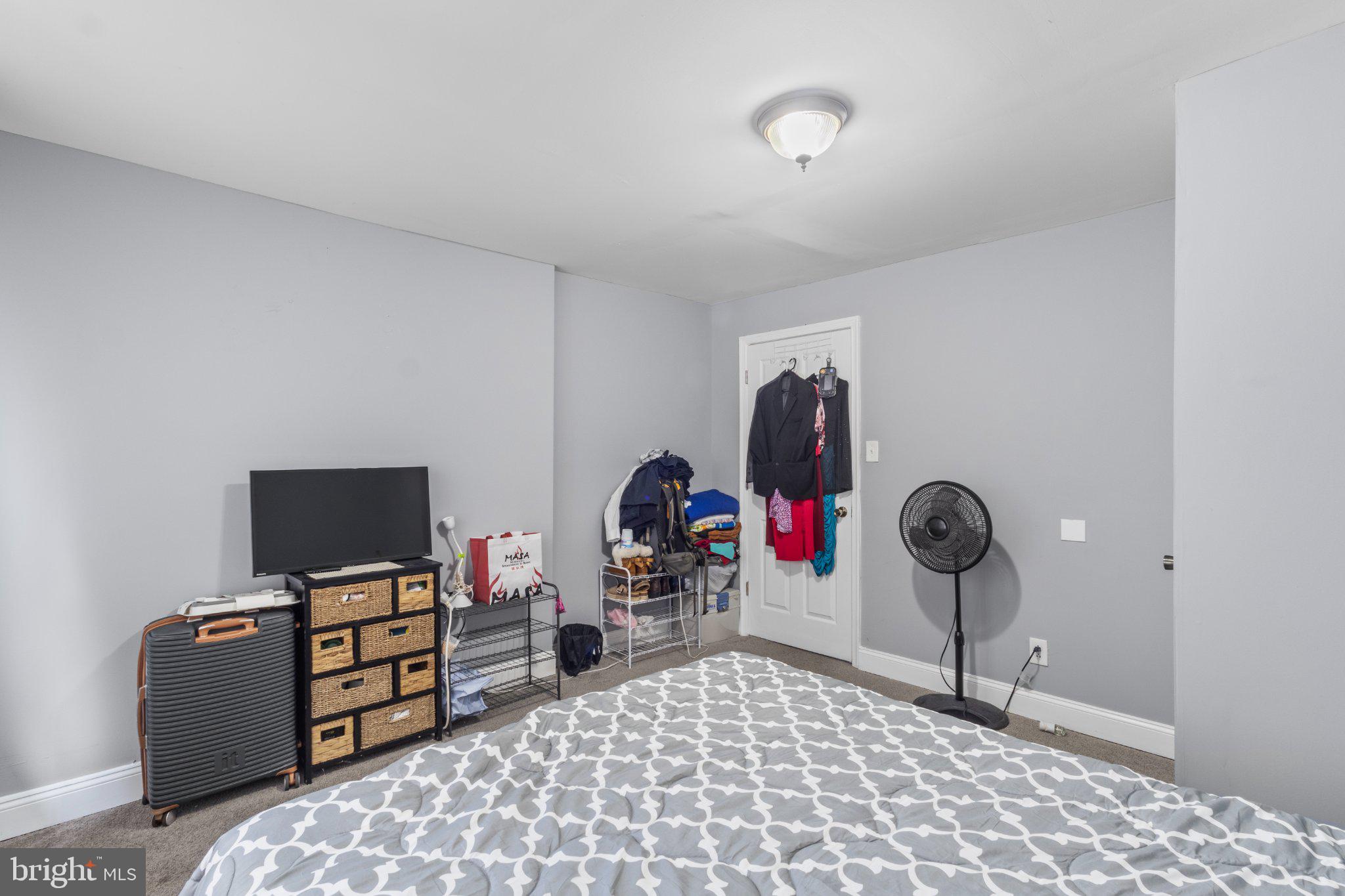 130 West Edgevale Road Baltimore, MD 21225 - Photo 30 of 37 a bedroom with a bed and a tv