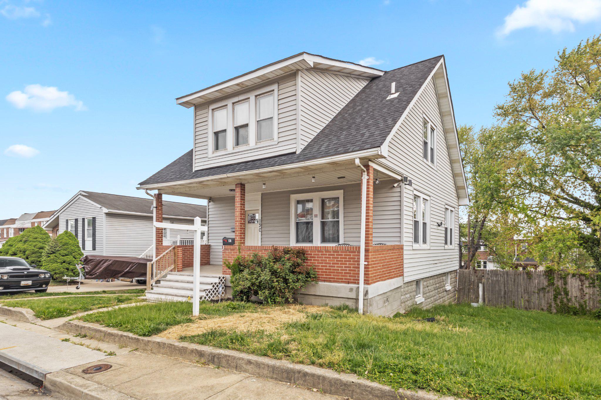 130 West Edgevale Road Baltimore, MD 21225 - Photo 3 of 37 a front view of a house with a yard