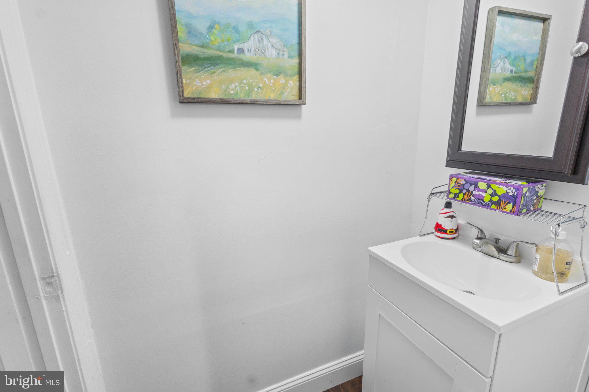 130 West Edgevale Road Baltimore, MD 21225 - Photo 31 of 37 a bathroom with a sink vanity and a window