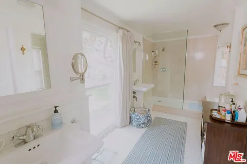 a bathroom with a bathtub a sink and a shower