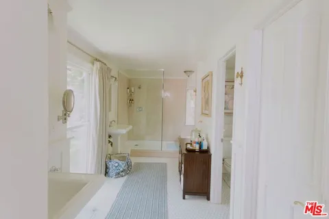 a bathroom with a shower and a tub