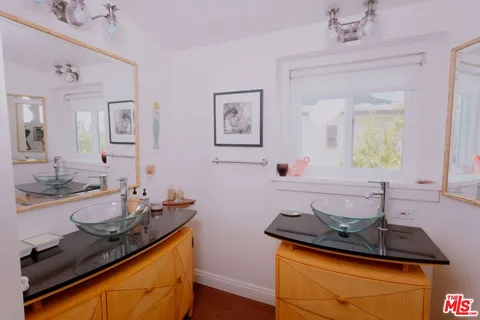a bathroom with sink and mirror
