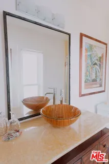 a bathroom with a granite countertop sink a toilet and shower
