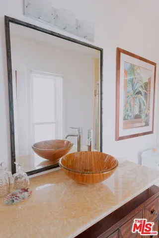 a bathroom with a granite countertop sink a toilet and shower