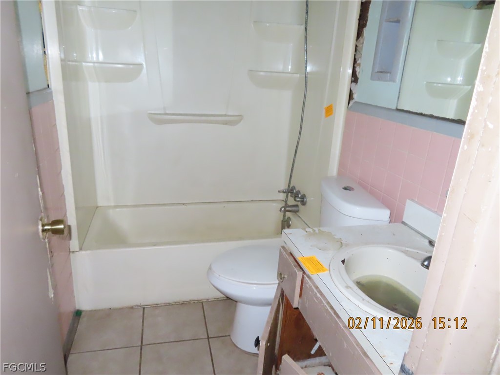 2254 Dora Street Fort Myers, FL 33901 - Photo 8 of 10 a bathroom with a sink a toilet and bathtub