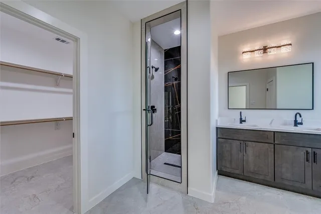 a bathroom with a double vanity sink and mirror