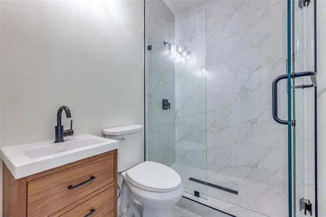 a bathroom with a toilet sink and shower