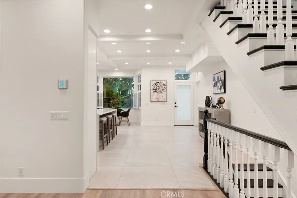 a view of a hallway with dining area and chandelier