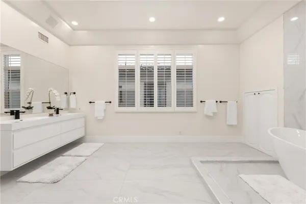 a spacious bathroom with a large tub and shower