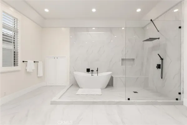a bathroom with a bathtub and a shower