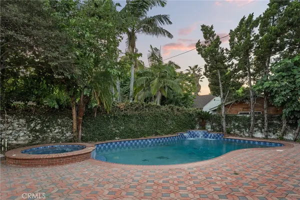 a view of a backyard with large trees