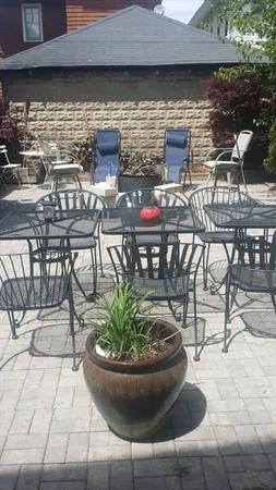 a view of a patio with table and chairs potted plants