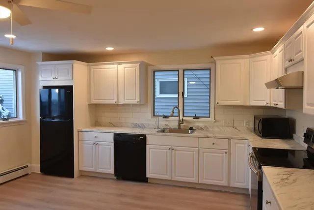 a kitchen with a sink stove and cabinets
