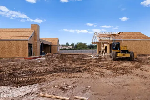 a view of a house with a large space and a car park front of a house