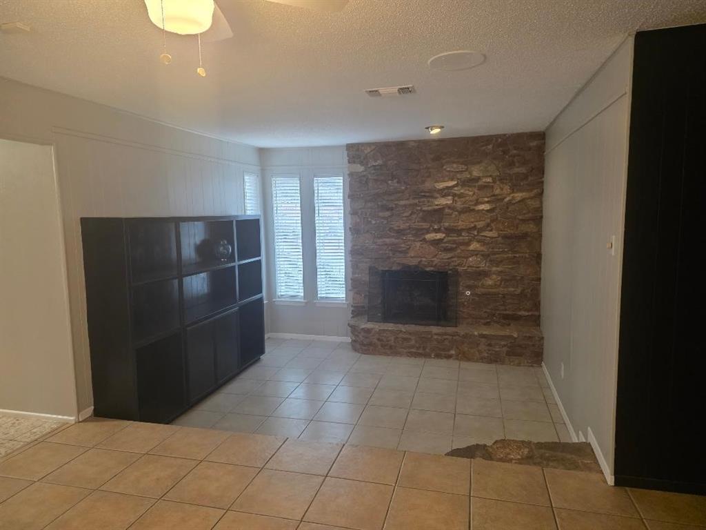 Undisclosed Address Hurst, TX 76054 - Photo 5 of 29 STEP DOWN INTO THE DEN WITH A STONE FIREPLACE, GAS STARTER, AND ADDITIONAL BOOKCASES