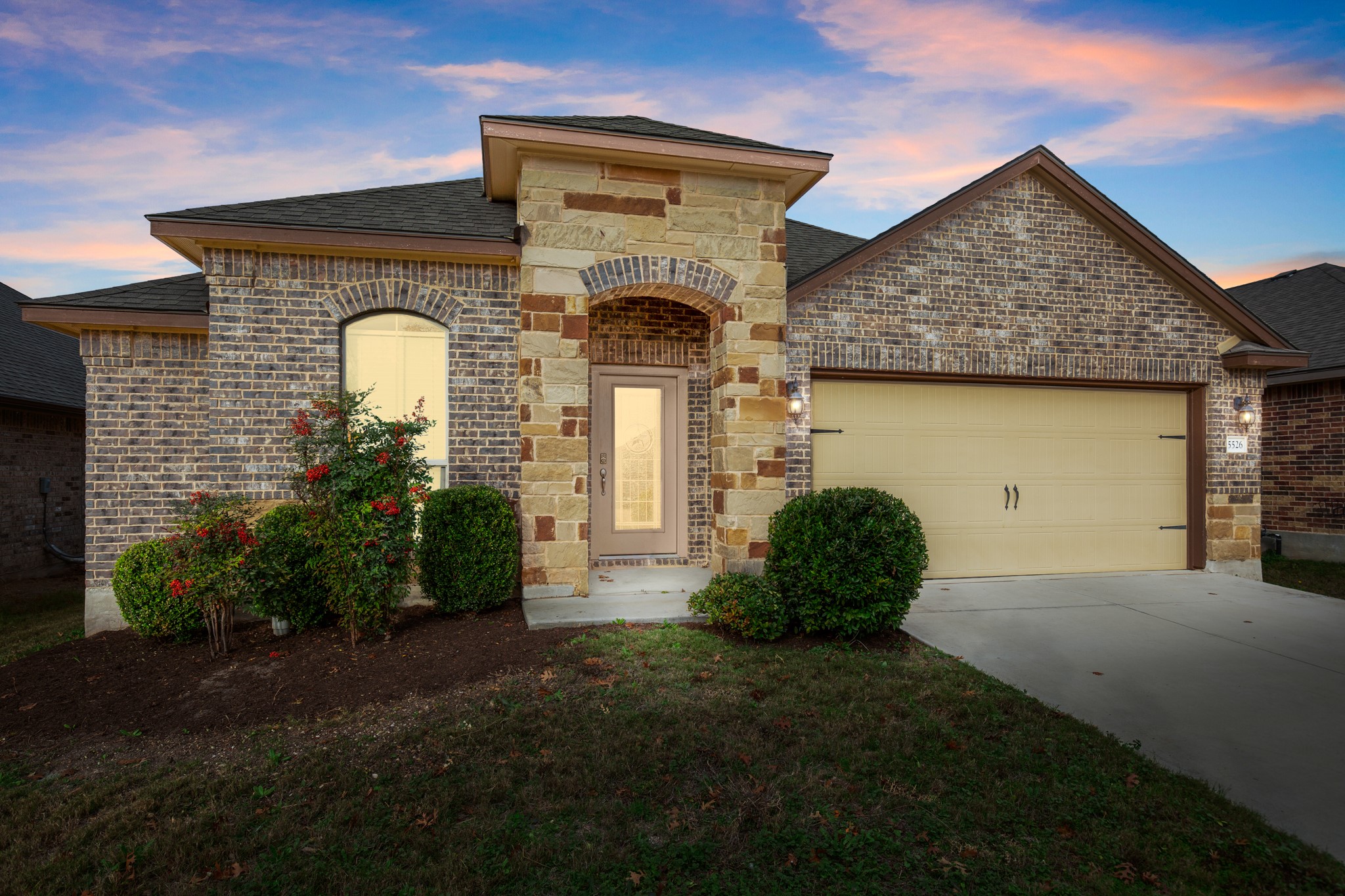 5526 Perdita Drive Belton, TX 76513 - Photo 1 of 26 French country style house with a garage, brick siding, driveway, stone siding, and a shingled roof