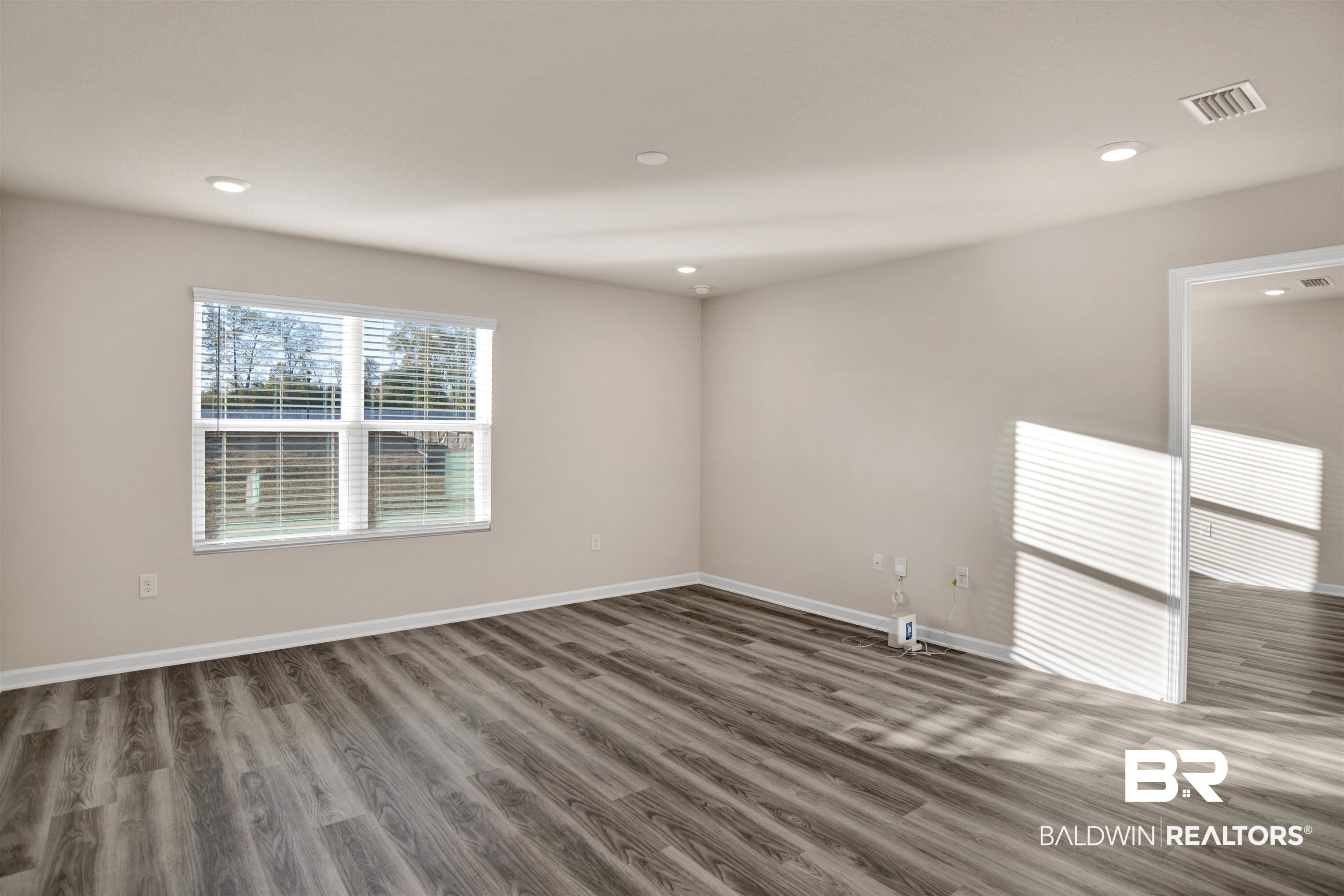 32038 Lyon Road Daphne, AL 36527 - Photo 23 of 30 Spare room featuring wood finished floors and recessed lighting