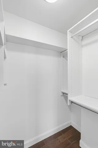 a view of walk in closet with empty racks