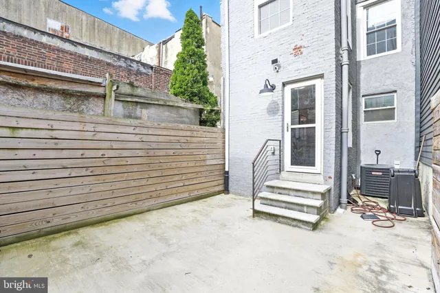 a view of a patio with table and chairs and stairs