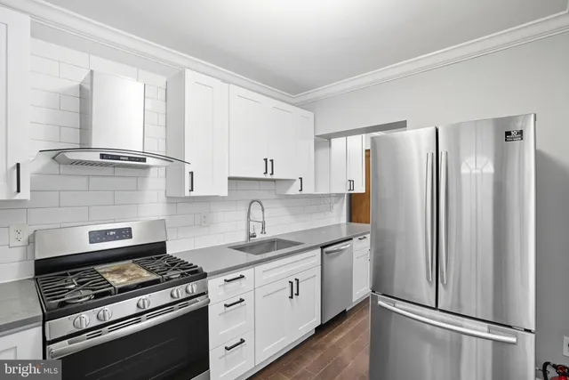 a kitchen with stainless steel appliances a refrigerator stove and sink