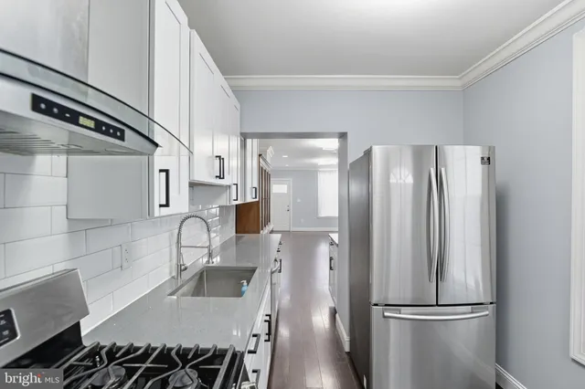 a kitchen with stainless steel appliances a refrigerator and a sink