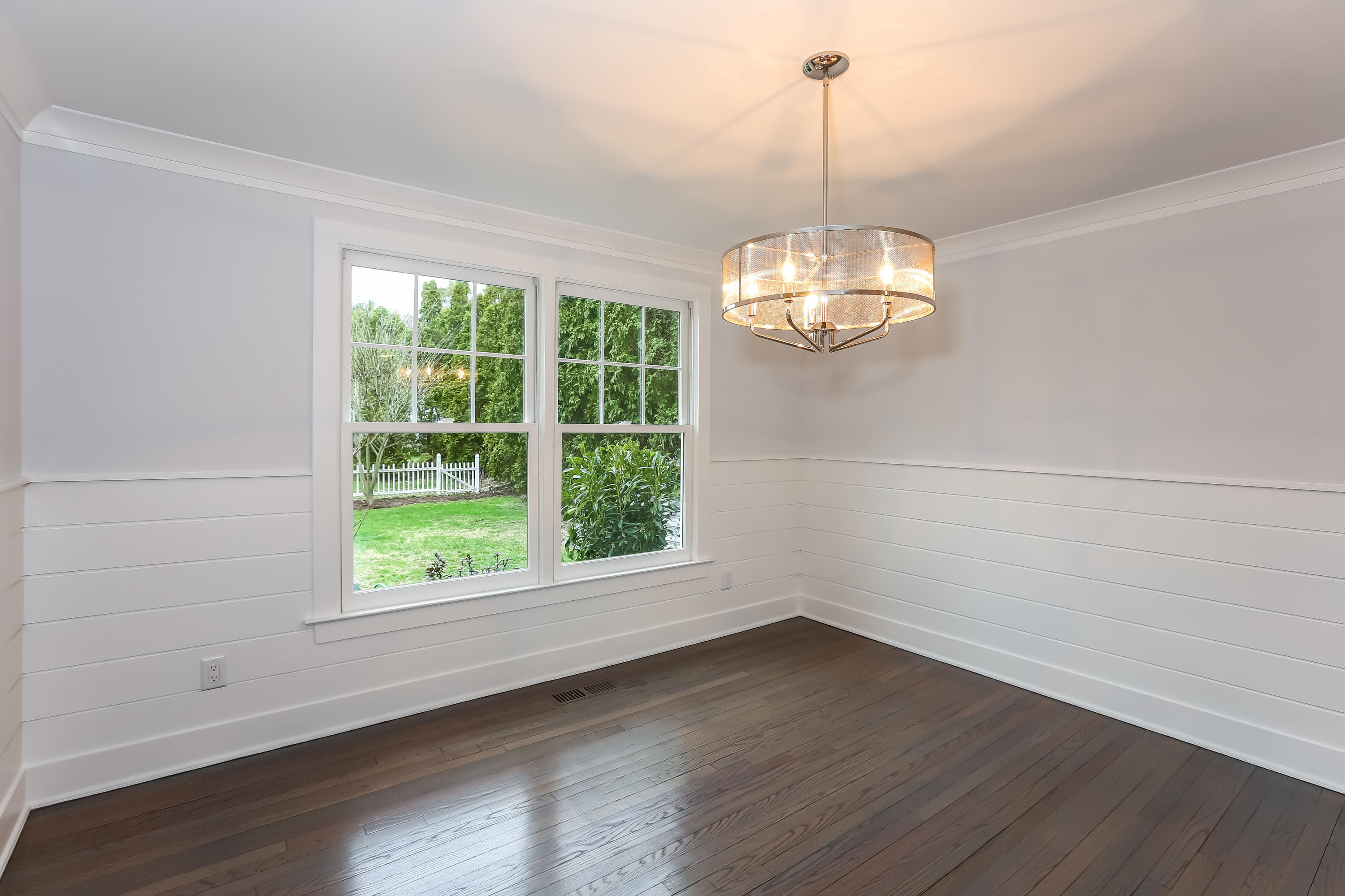 68 Relihan Road Darien, CT 06820 - Photo 6 of 27 an empty room with wooden floor and windows