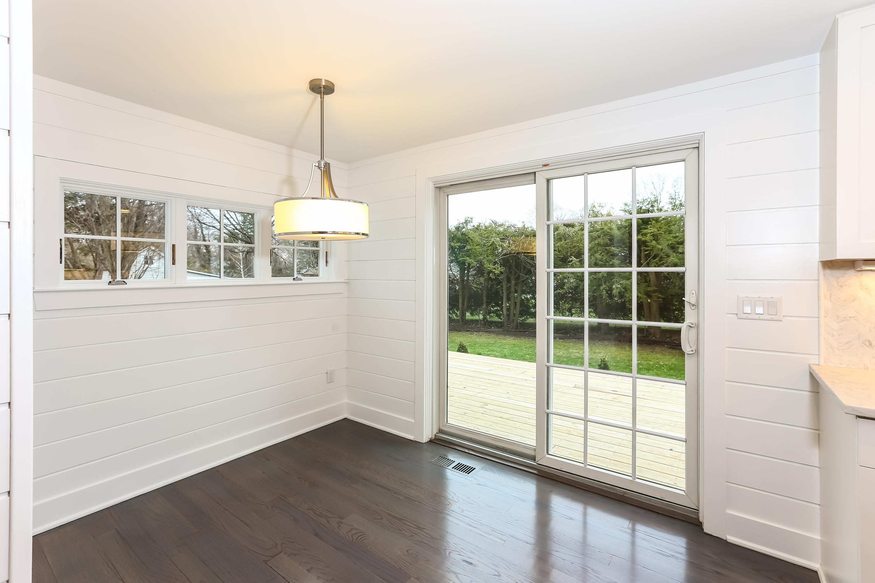 68 Relihan Road Darien, CT 06820 - Photo 10 of 27 a view of an empty room with wooden floor and a window
