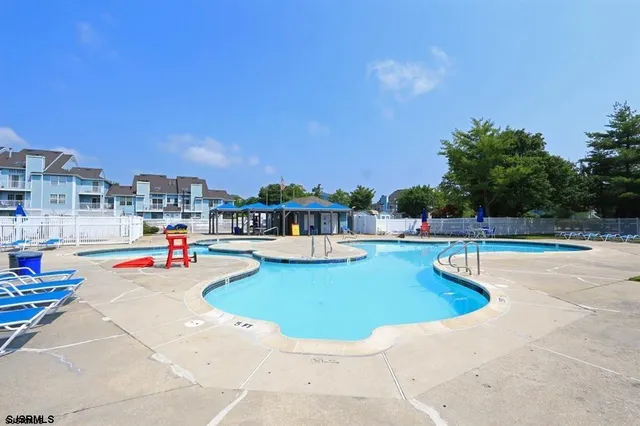 a view of a swimming pool and lounge chairs