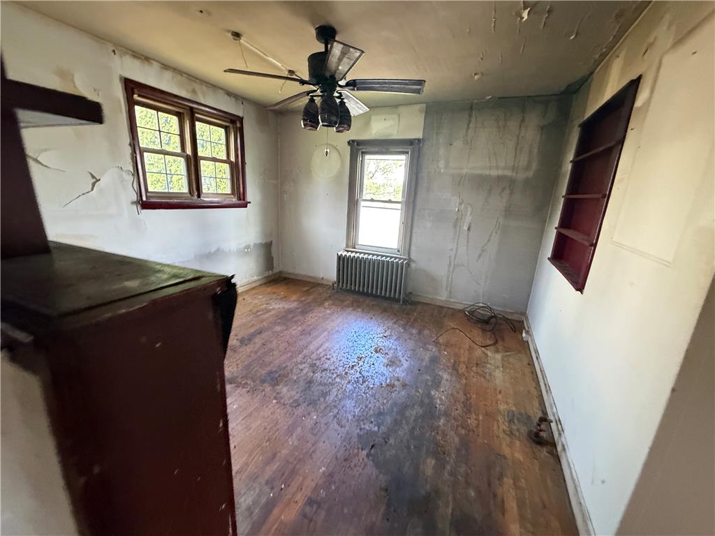 3051 Keystone Street Bethlehem, PA 18020 - Photo 9 of 18 Natural light filters into this bedroom, featuring original hardwood flooring ready for restoration.