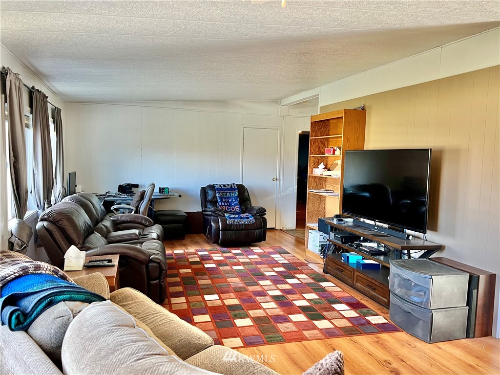 53 Woods Road Omak, WA 98841 - Photo 11 of 40 a living room with furniture and a flat screen tv