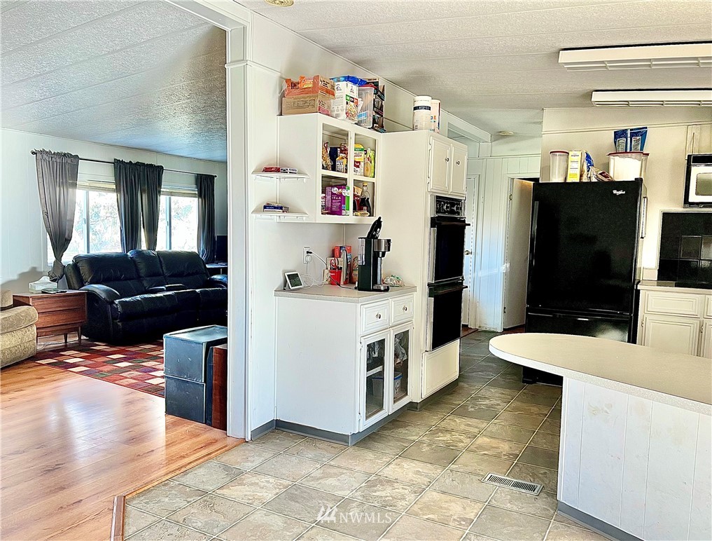 53 Woods Road Omak, WA 98841 - Photo 14 of 40 a living room with stainless steel appliances furniture and a flat screen tv