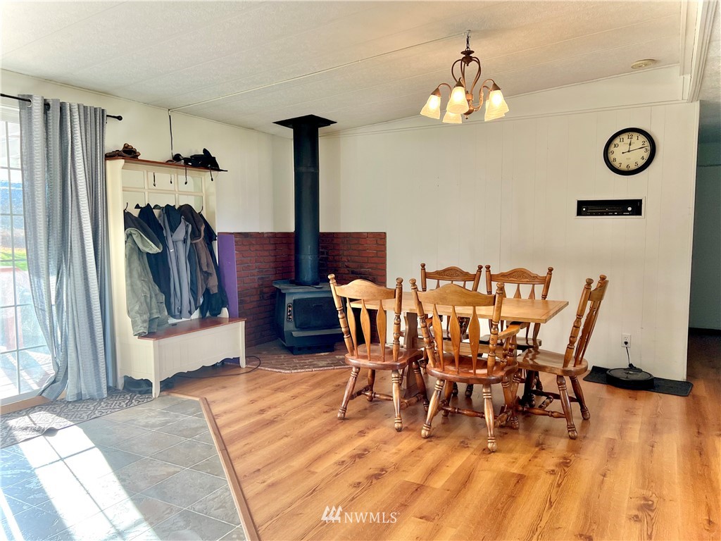 53 Woods Road Omak, WA 98841 - Photo 18 of 40 a view of a dining room with furniture and wooden floor