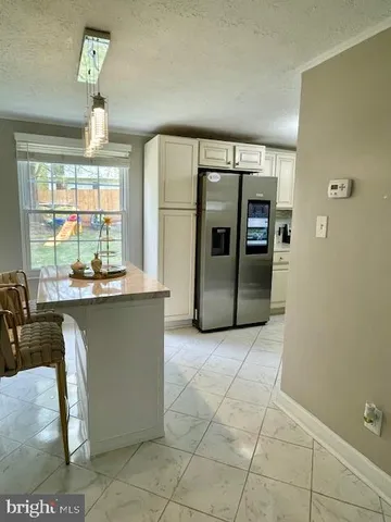a vase of flowers sitting on a table with chairs