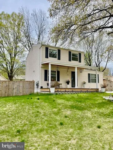 a view of a house with a yard porch and sitting area
