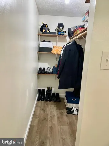 a view of patio with table and chairs under an umbrella with a barbeque grill and couches
