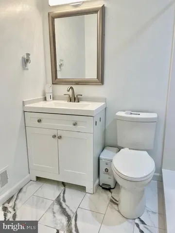 a view of patio with table and chairs under an umbrella with a small swimming pool