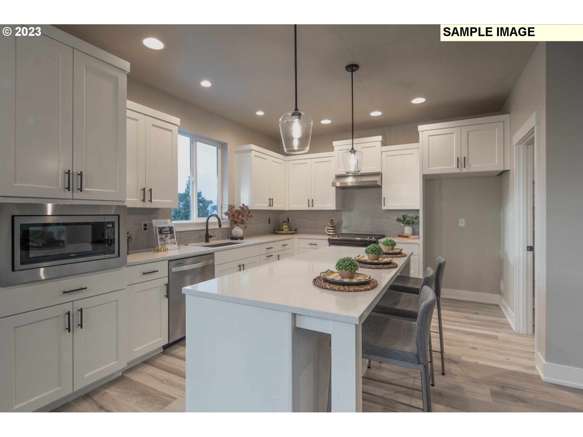 3705 South 44th Avenue Ridgefield, WA 98642 - Photo 3 of 13 a kitchen with a sink a stove a refrigerator and white cabinets