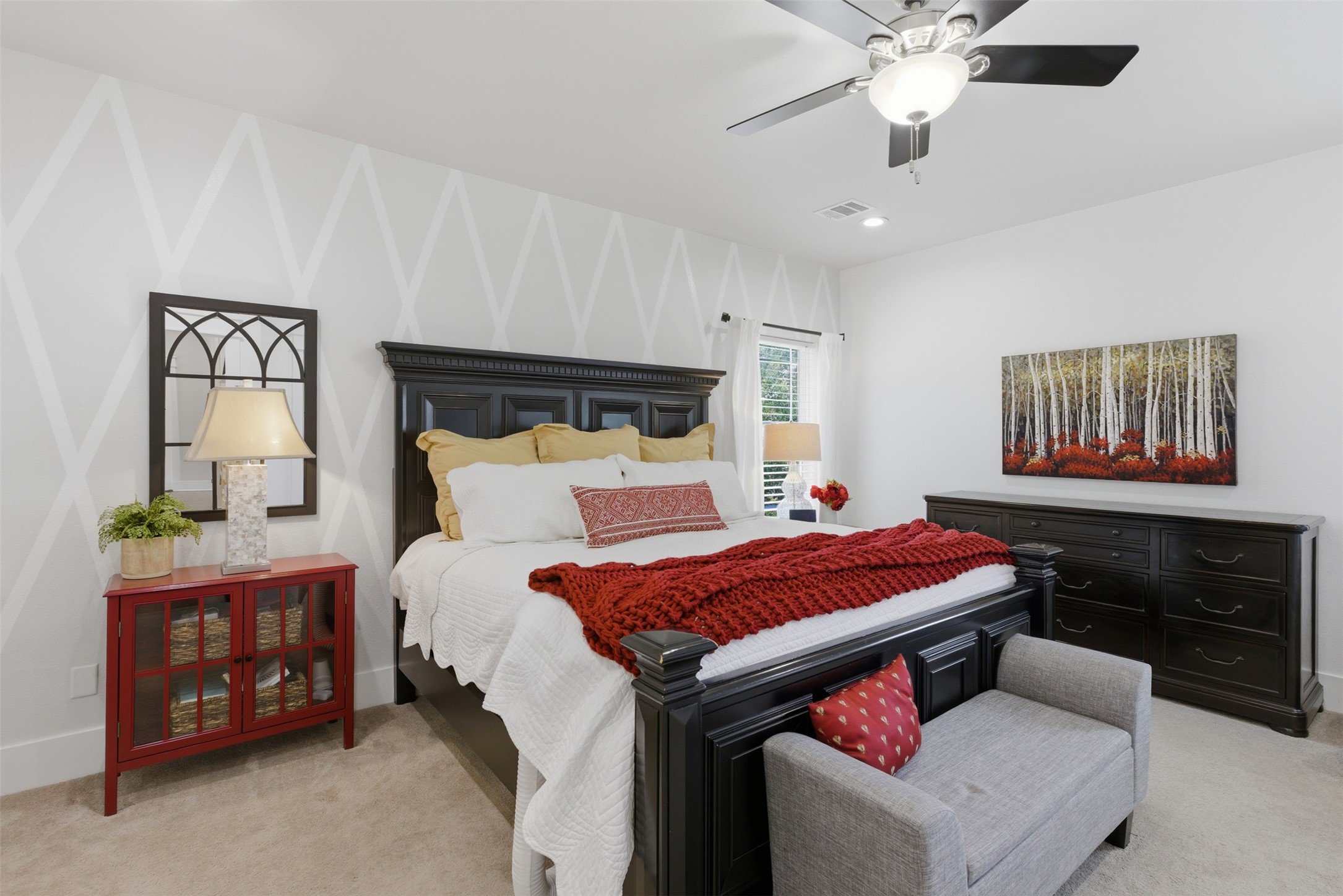 1804 Tanner Loop Taylor, TX 76574 - Photo 12 of 40 The primary suite features a chic accent wall and recessed lighting.