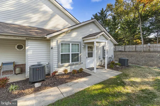 a view of a house with backyard porch and sitting area