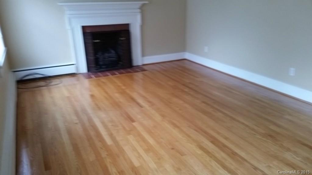 403 Shue Road China Grove, NC 28023 - Photo 5 of 15 a view of an empty room with wooden floor and a fireplace