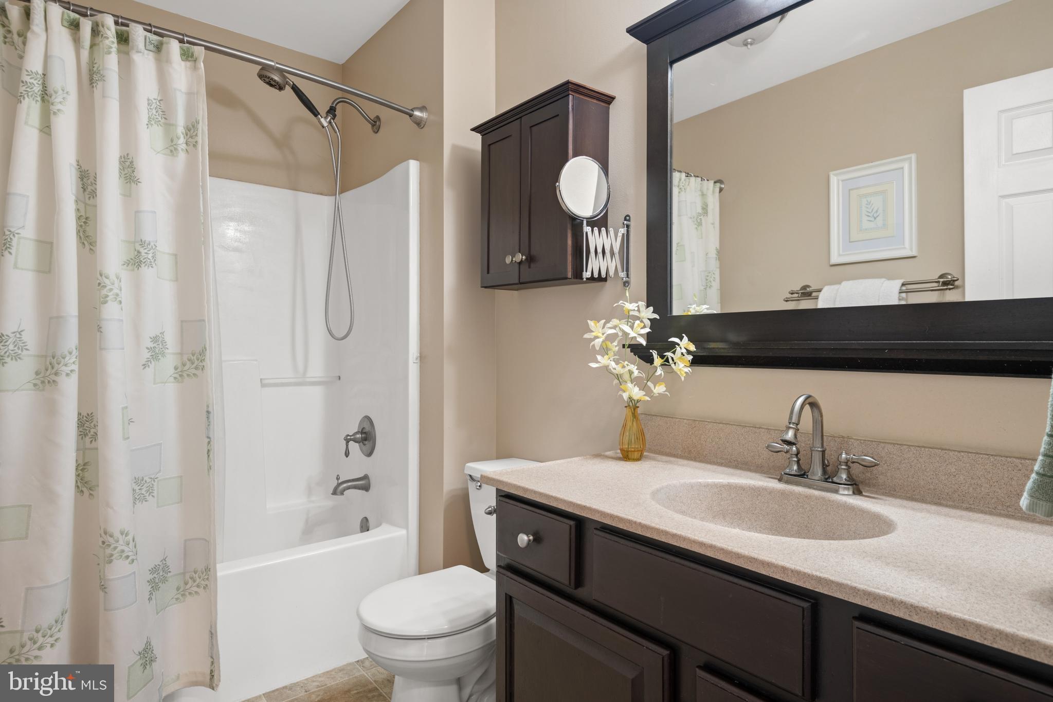 16 Pebble Creek Drive Lititz, PA 17543 - Photo 16 of 37 a bathroom with a granite countertop sink a toilet a mirror a vanity a shower and bathtub