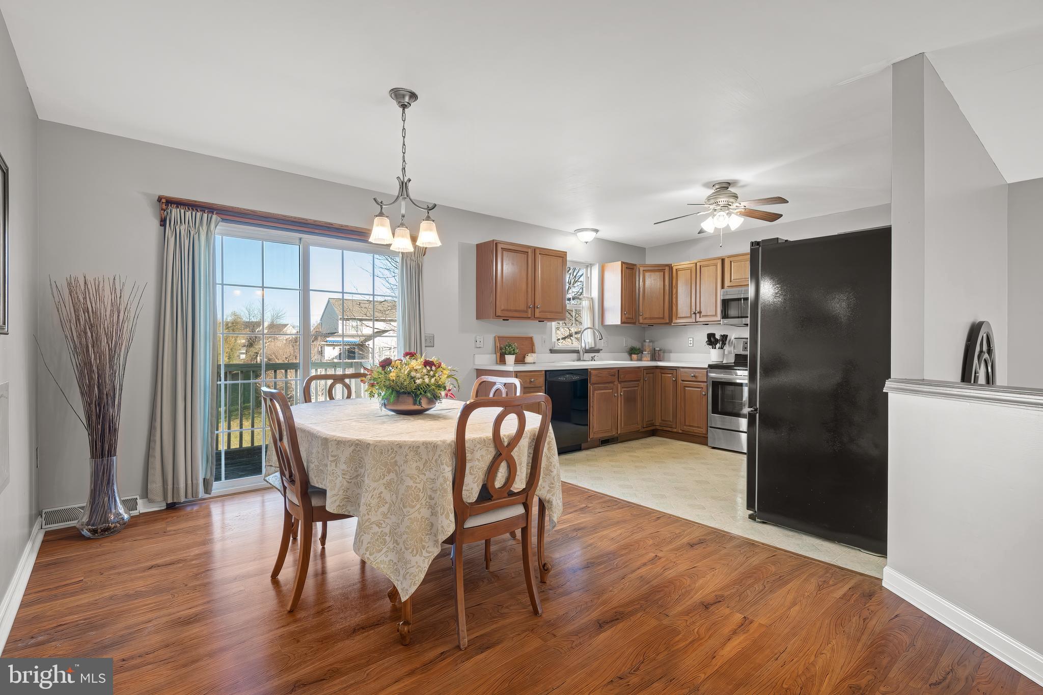 16 Pebble Creek Drive Lititz, PA 17543 - Photo 7 of 37 a kitchen with stainless steel appliances a dining table chairs refrigerator and cabinets