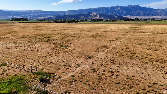 2070 East Tbd Road North Richfield, UT 84701 - Photo 20 of 35 Expansive open terrain with visible irrigation system, framed by distant mountains and a clear sky
