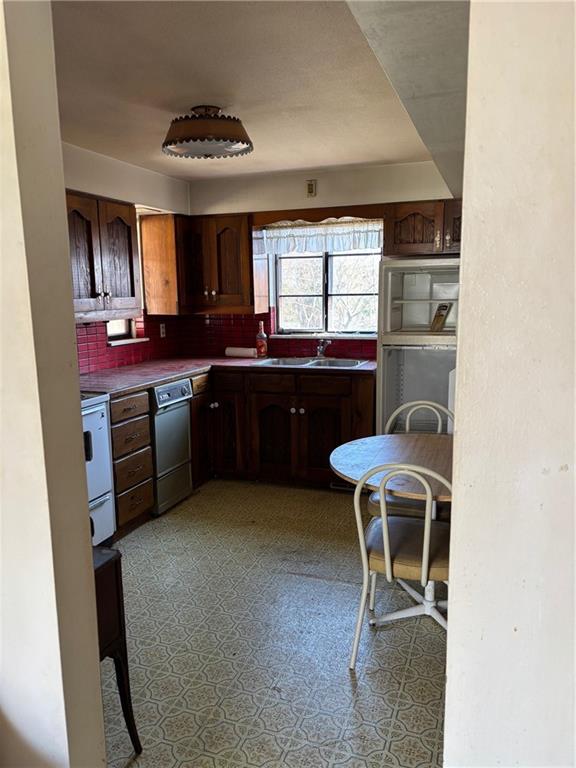 1800 McCully Road Pittsburgh, PA 15234 - Photo 3 of 12 a kitchen with stainless steel appliances granite countertop a stove a sink and a refrigerator