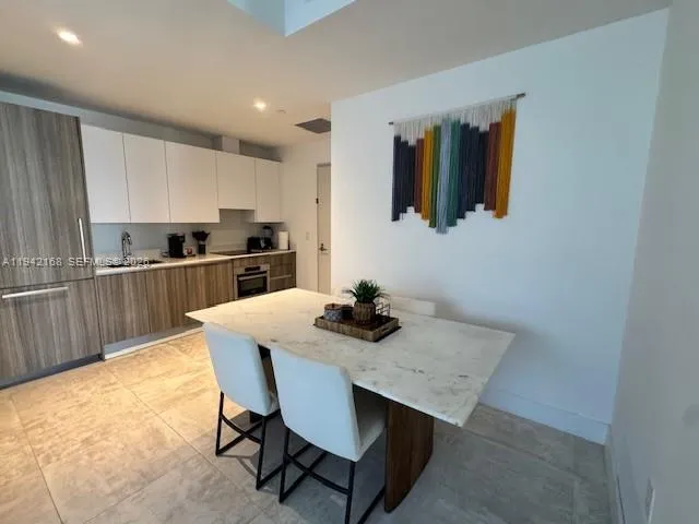a kitchen with a table and chairs in it